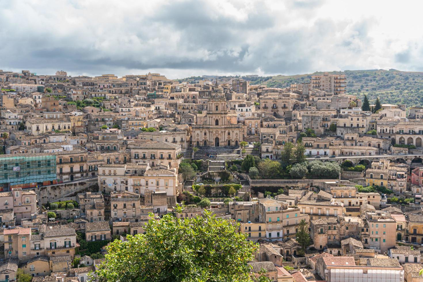 Modica, Italy-May 8, 2022-Panoramic view of the characteristic city of Modica and its cathedral of San Giorgio in Sicily during a cloudy day photo