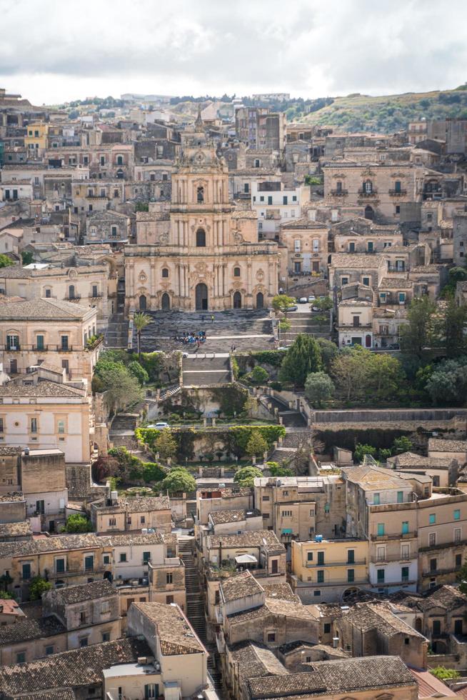 Modica, Italy-May 8, 2022-Panoramic view of the characteristic city of Modica and its cathedral of San Giorgio in Sicily during a cloudy day photo