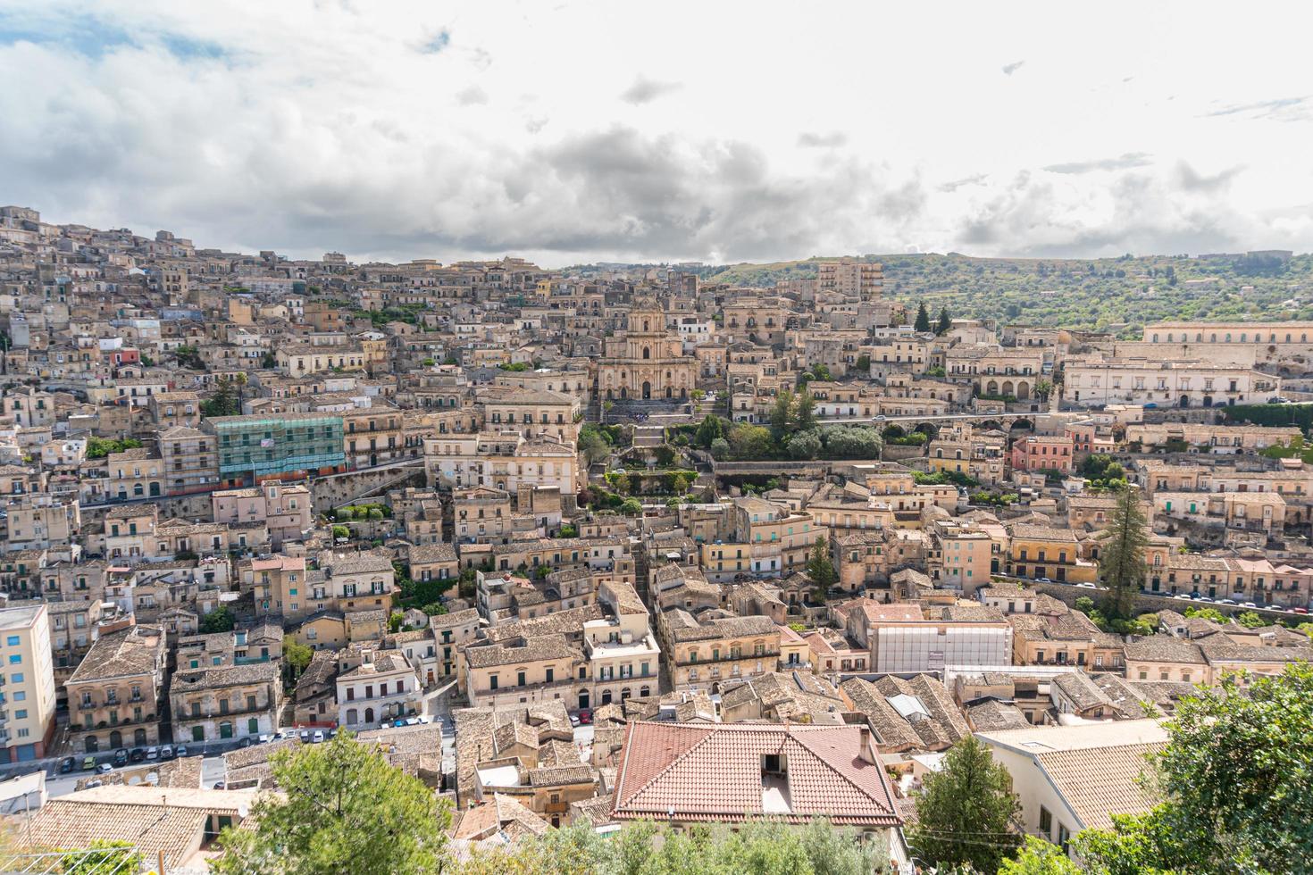Modica, Italy-May 8, 2022-Panoramic view of the characteristic city of Modica and its cathedral of San Giorgio in Sicily during a cloudy day photo