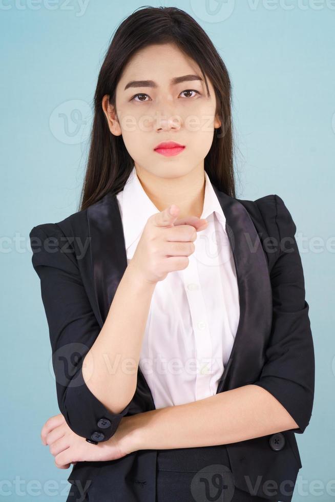 Woman looking at camera and pointing finger photo