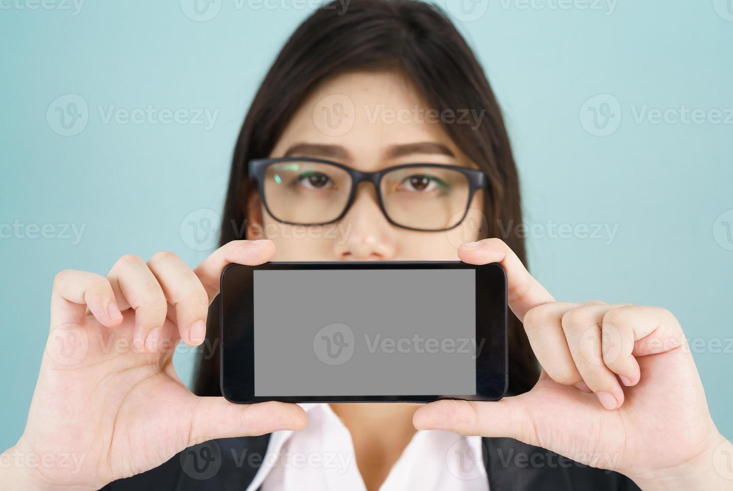 Young women in suit holding her smartphone photo