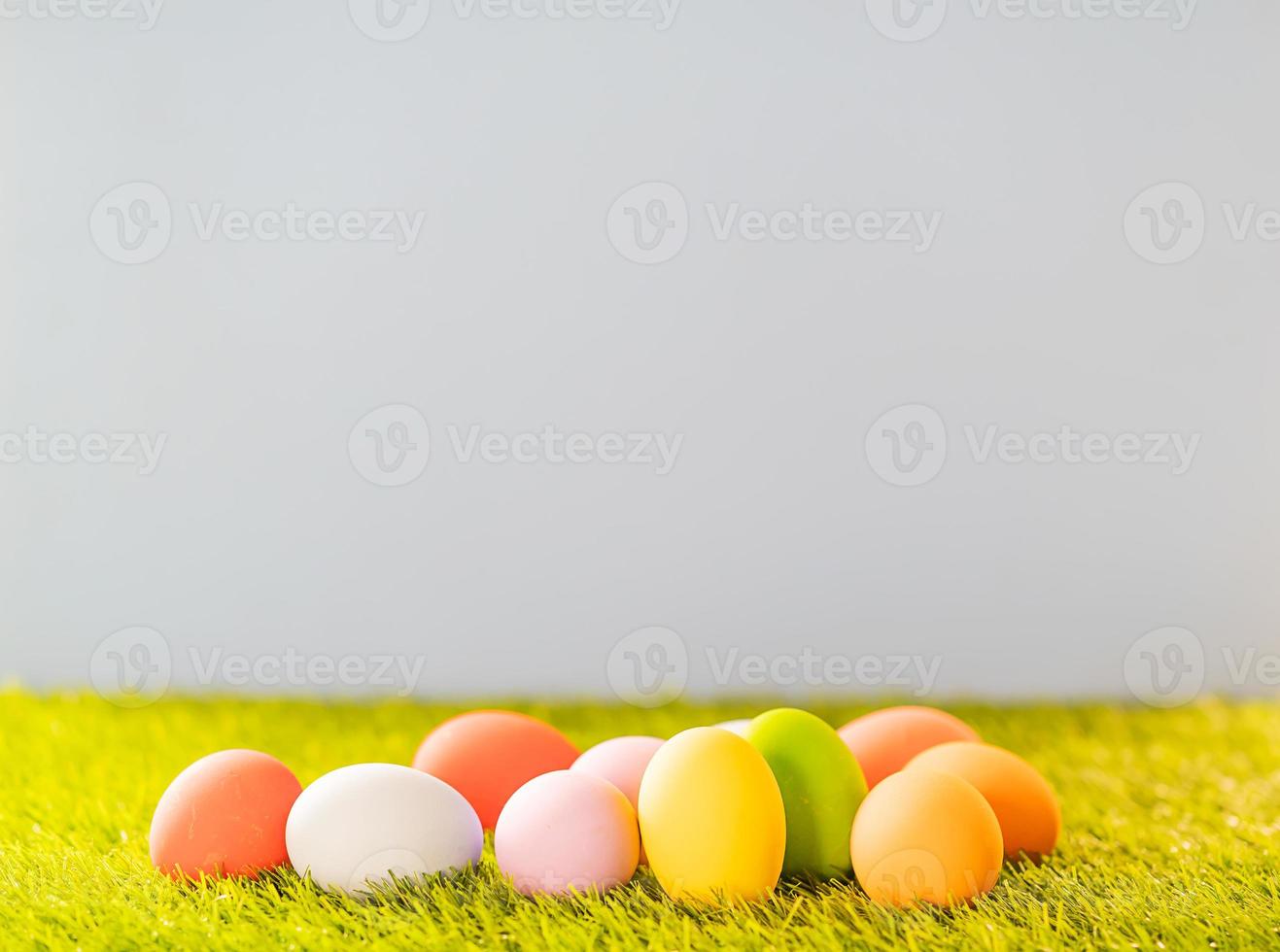 Colorful Easter eggs on green grass photo