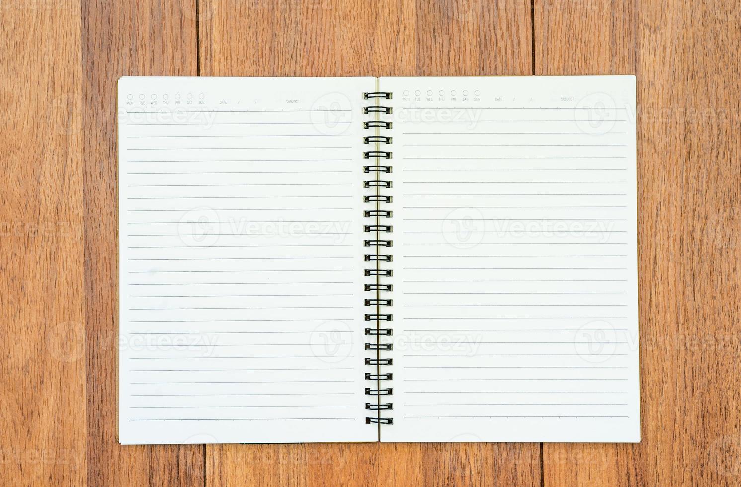 Top view image of open notebook with blank pages on wooden table photo