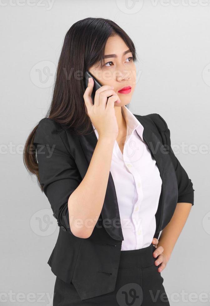 Asian women in suit standing posing using  phone photo