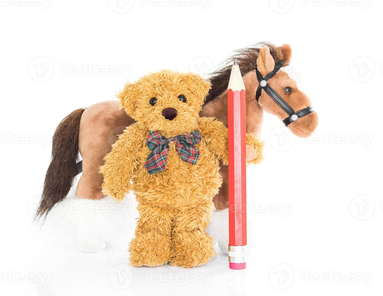 Teddy bear with red pencil and horses photo