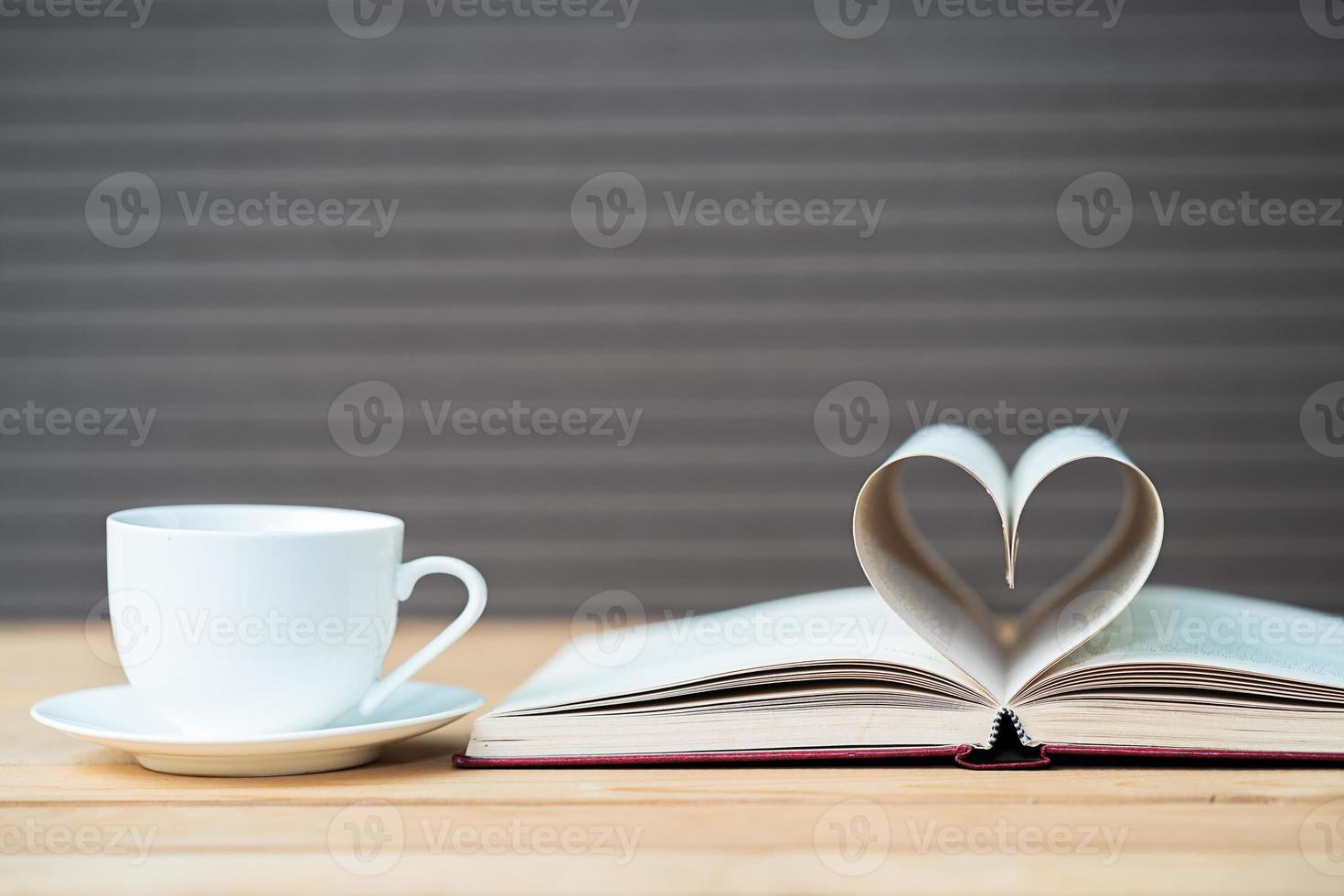 Page of book curved  heart shape and coffee cup photo