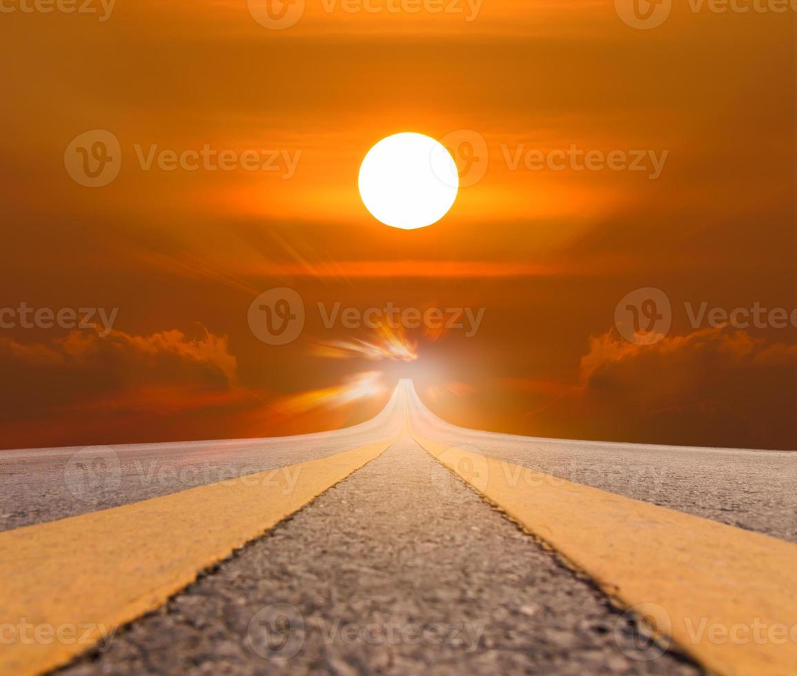 Road asphalt suspended to big sun photo