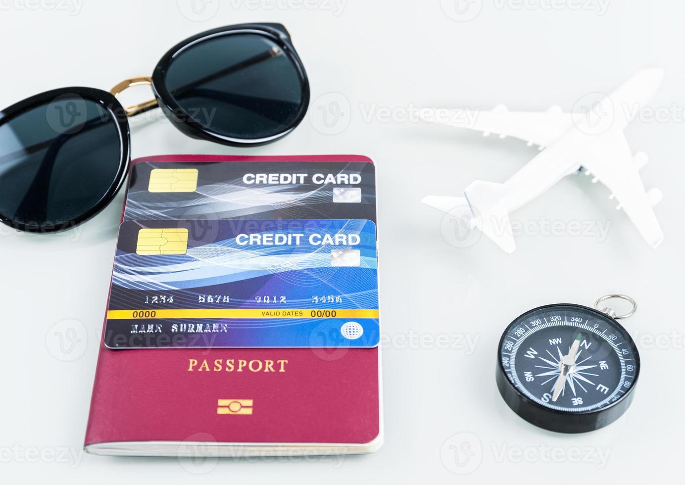 Passports and credit cards,sunglases,airplane on white photo