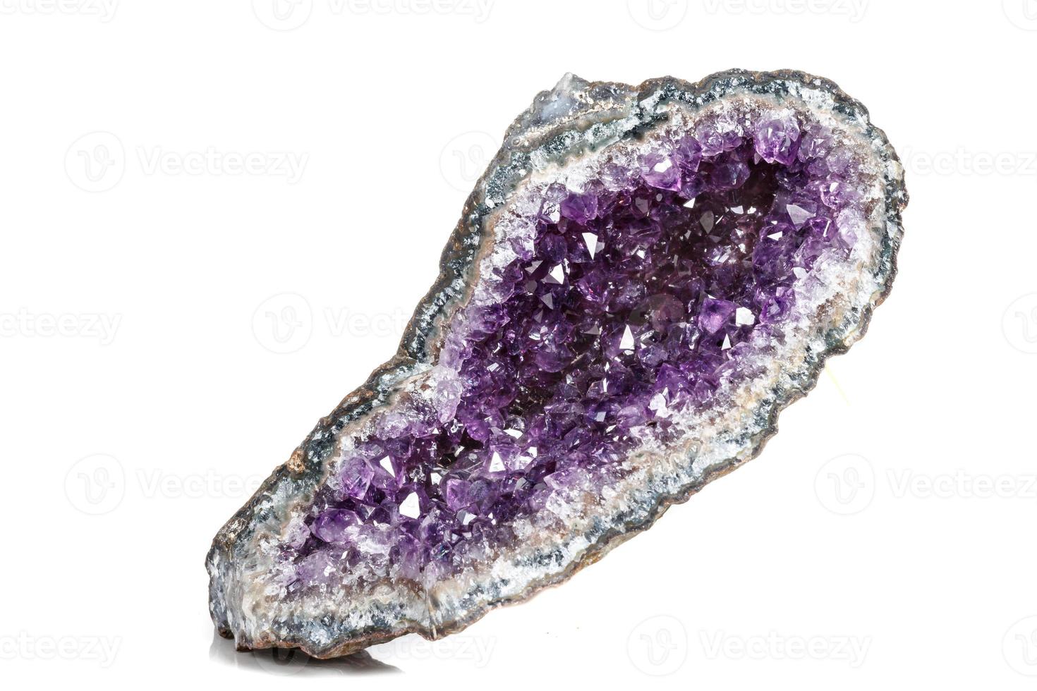 Macro Mineral Stone Amethysts in the rock on a white background photo