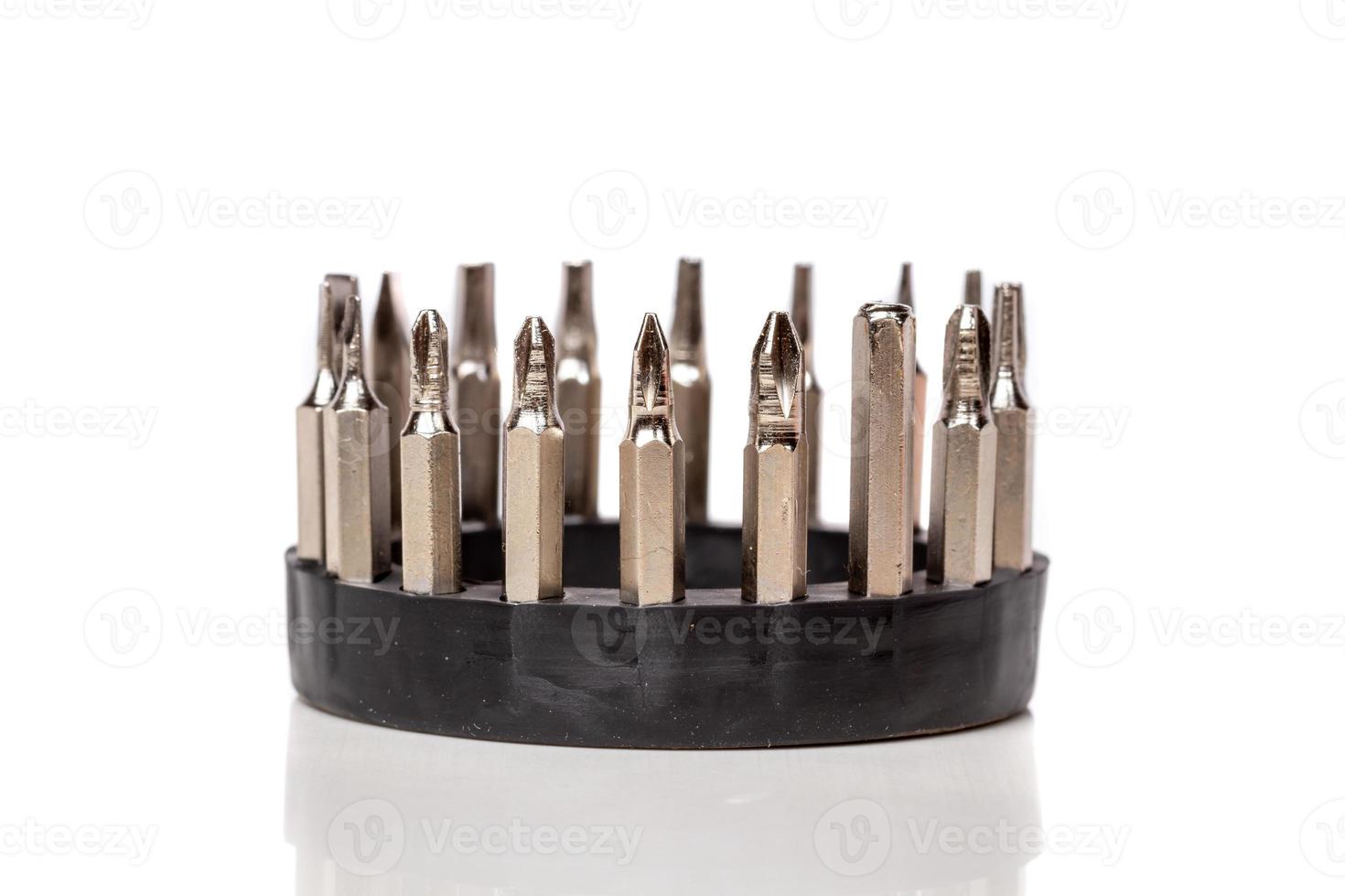 A set of different attachments for a head screwdriver with a screwdriver on a white background photo