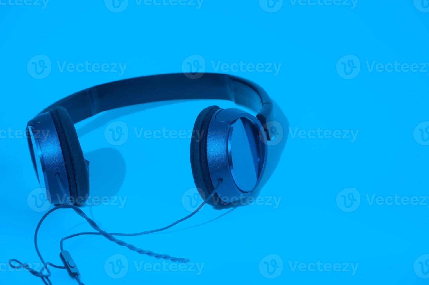Headphones on blue background photo
