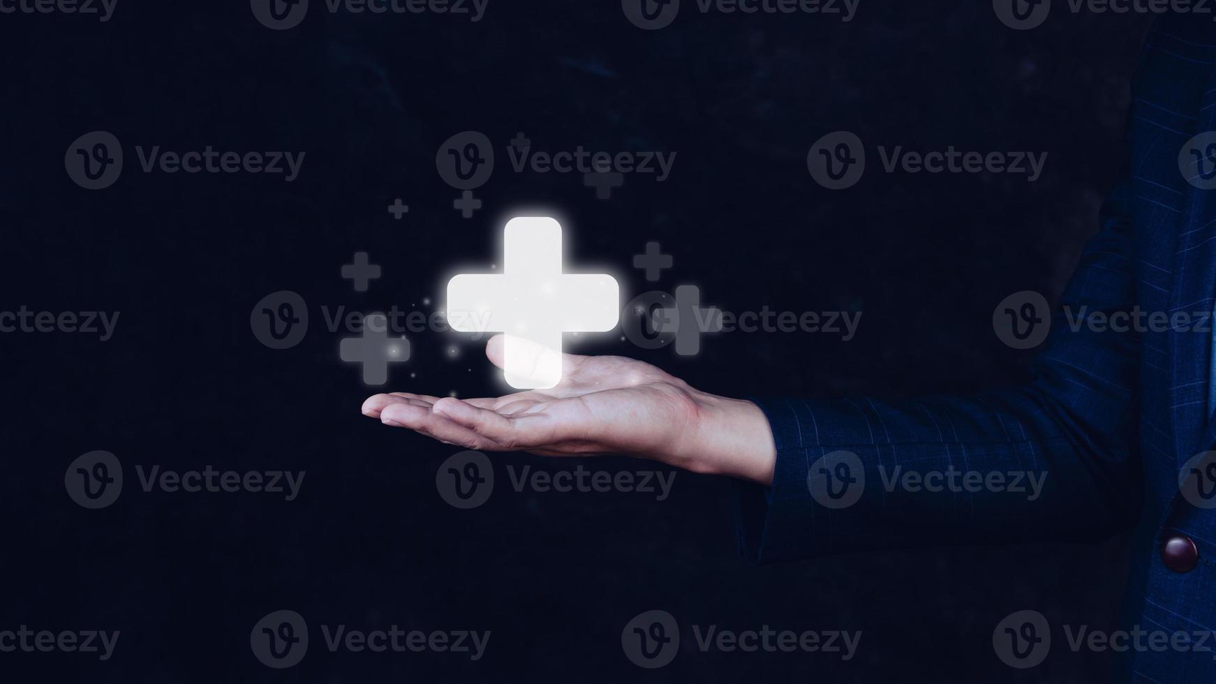 Businessman hold in hand offer positive thing such as profit, benefits, development, CSR represented by plus sign.The hand shows the plus sign. e.g. personal development benefits, social network, photo