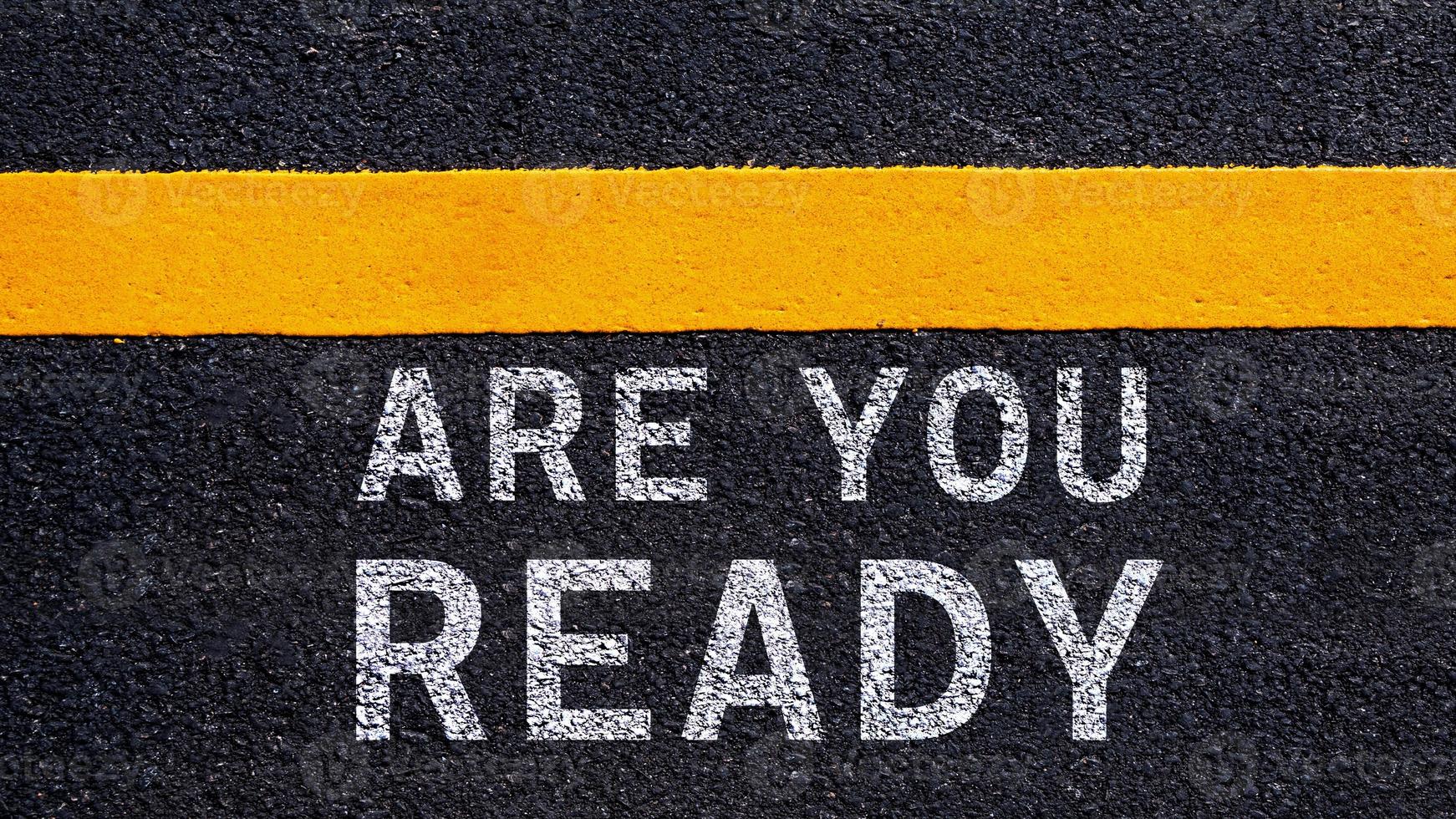 Are you ready written on the middle of the asphalt with yellow line road. Are you ready Write on the road in the middle of the empty asphalt road photo