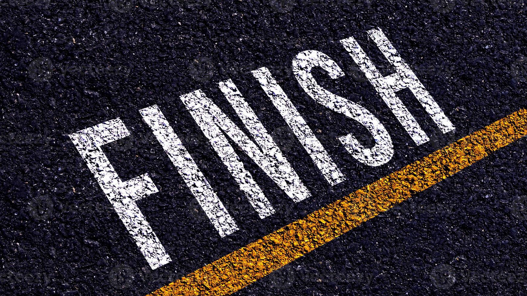 Finish text written and yellow line on the road in middle of the asphalt road, for business planning strategies and challenges, road to success concept, Finish word on street photo
