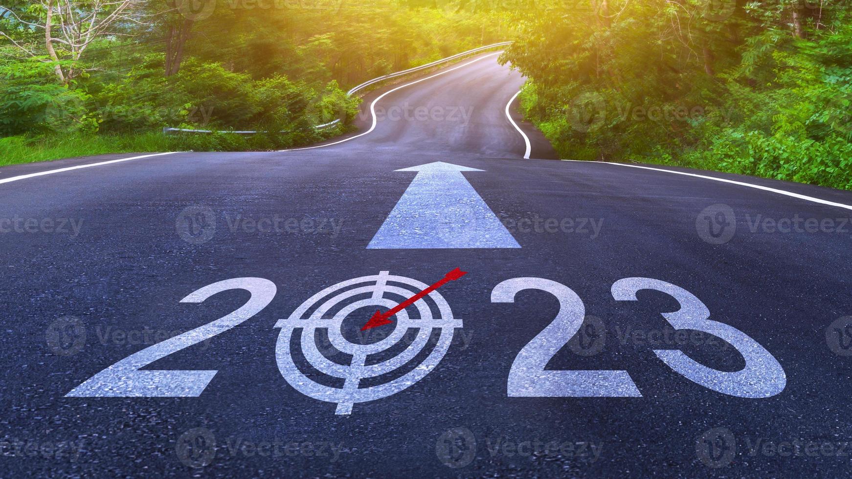 New year 2023 or straight forward concept. Text 2023 written on the road in the middle of asphalt road, Concept of planning, goal, challenge, new year resolution. photo