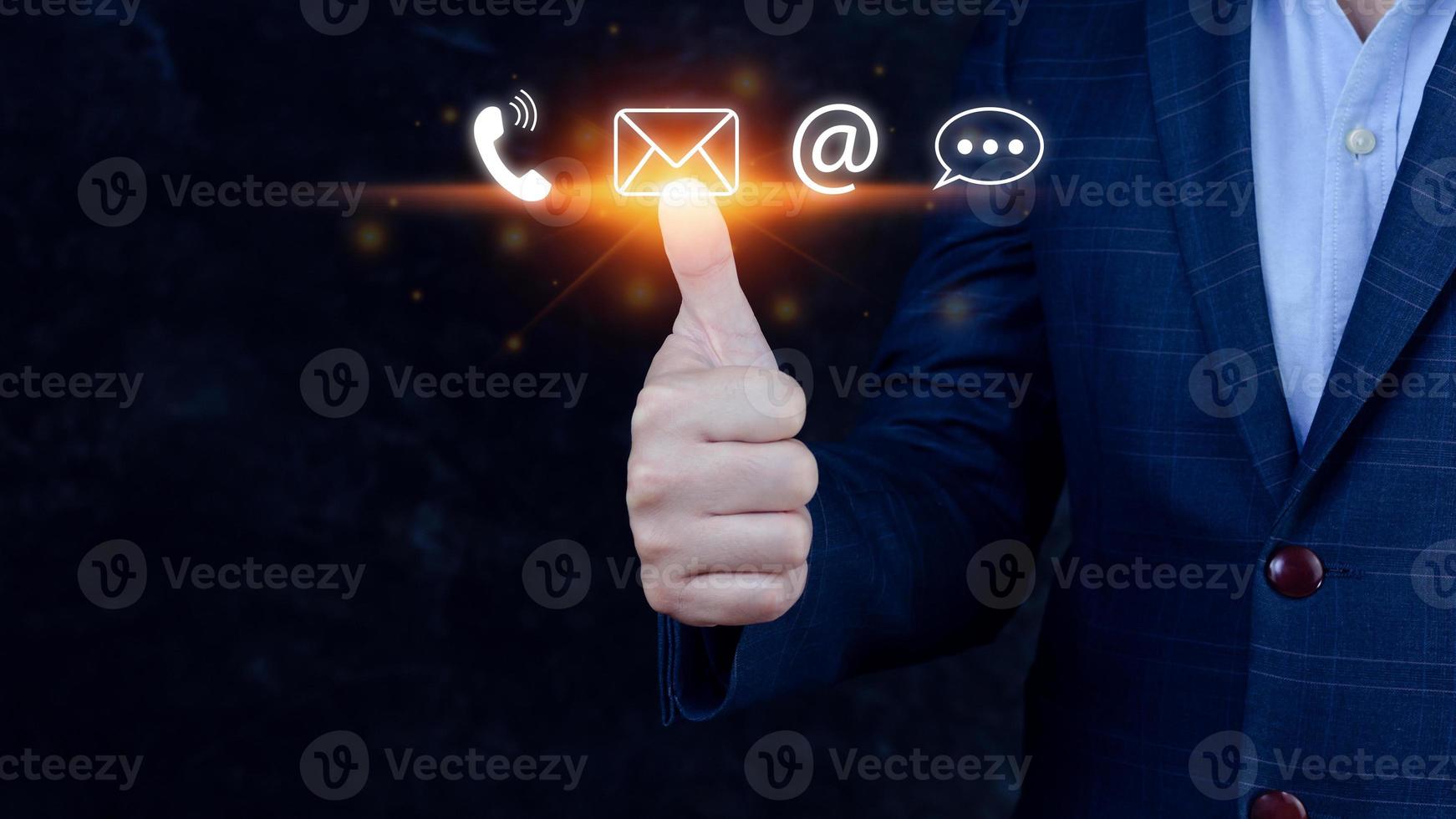 Contact us or Customer support hotline people connect. Businessman using showing and touching on virtual screen contact icons call phone, email, address, live chat, photo