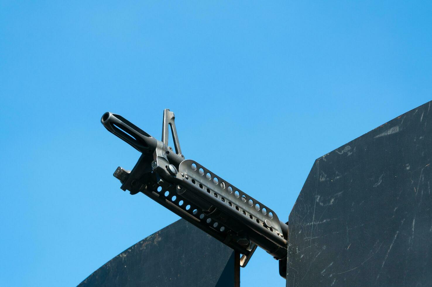 Gun weapons close-up ,machine gun on blue sky,Machine gun on a military vehicle photo