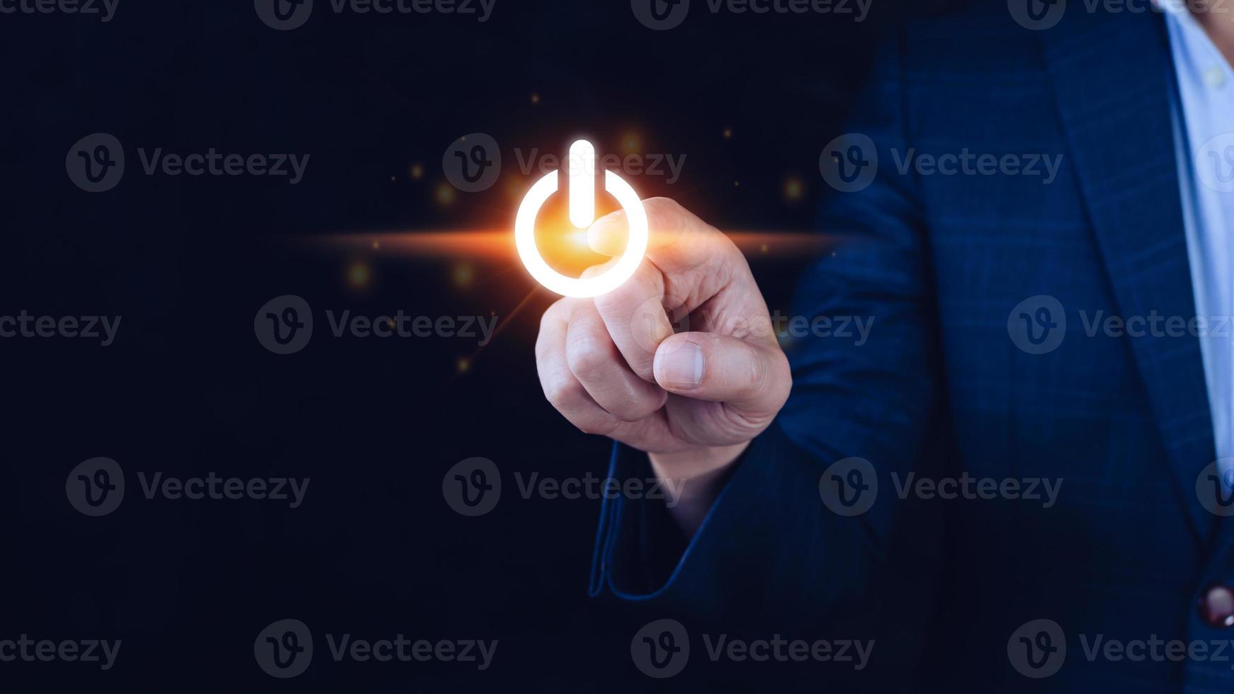 Businessman pushing visual touch screen power button with his finger