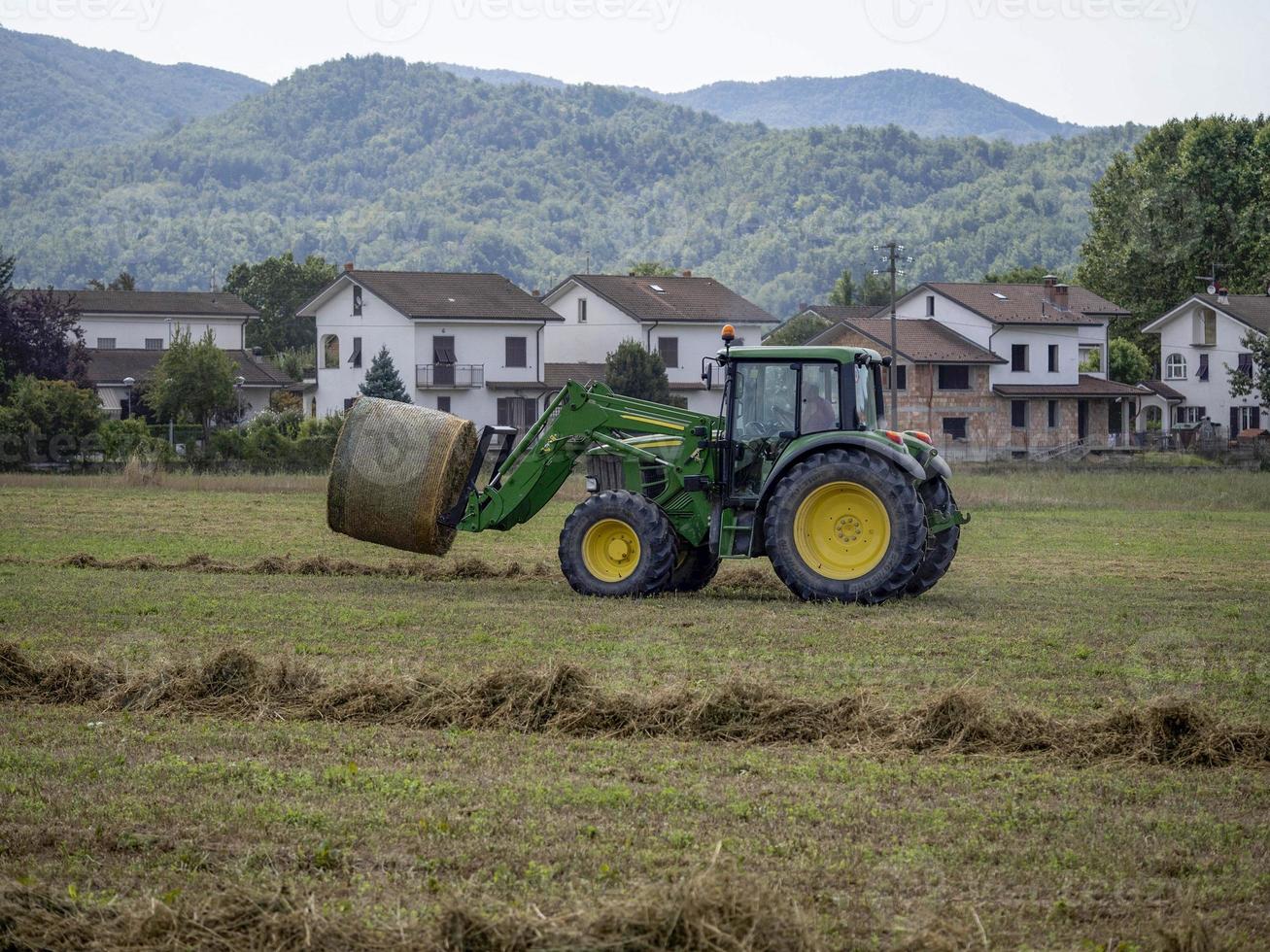 tractor moving wheat ball in the field photo