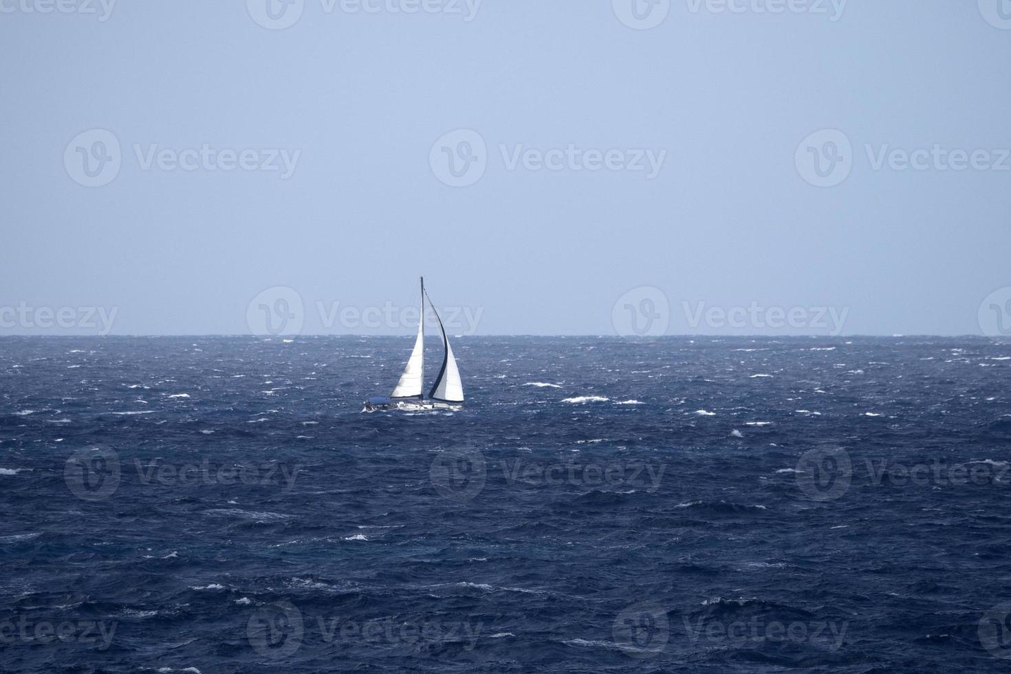 sail boat in high waves sea photo