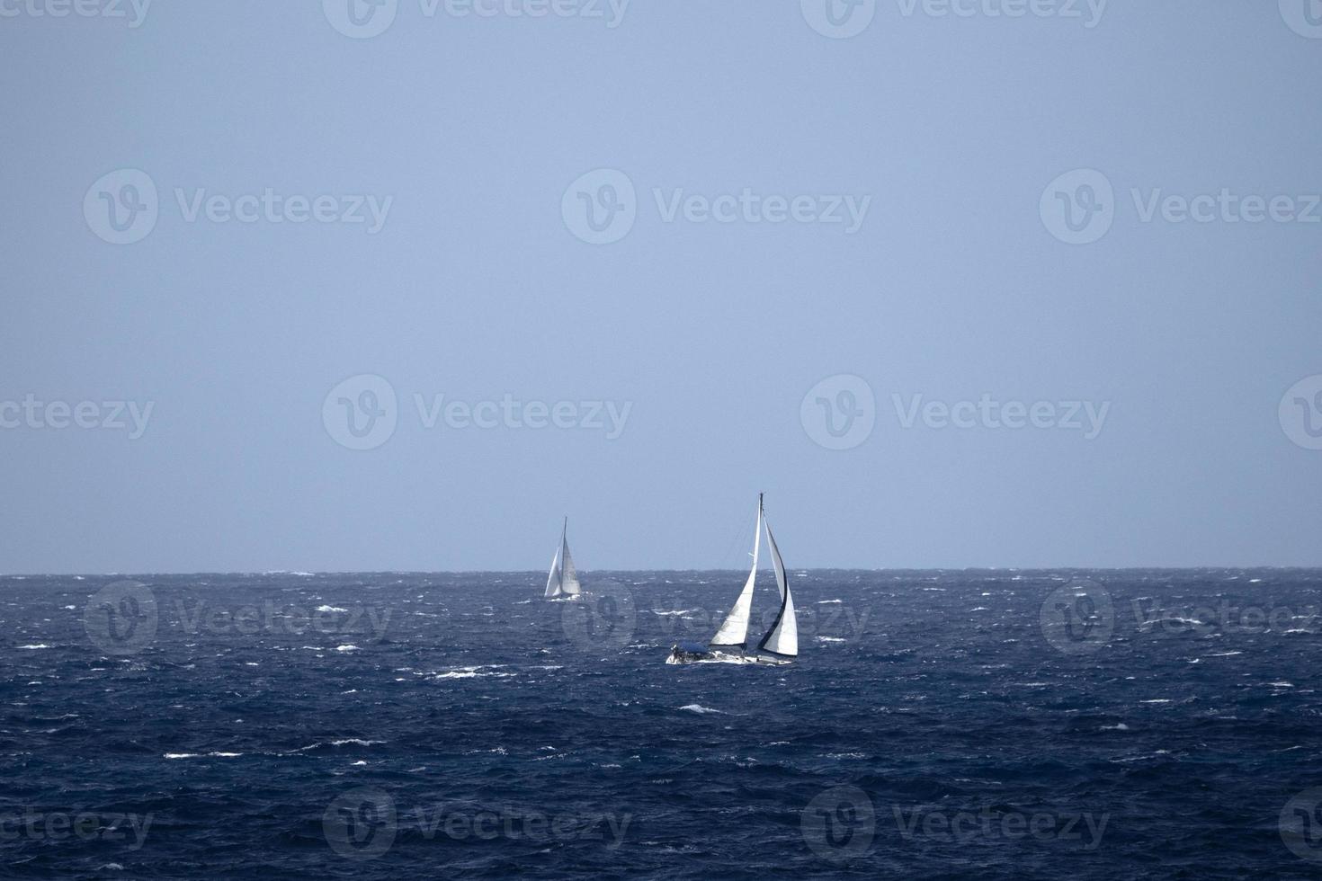 sail boat in high waves sea photo