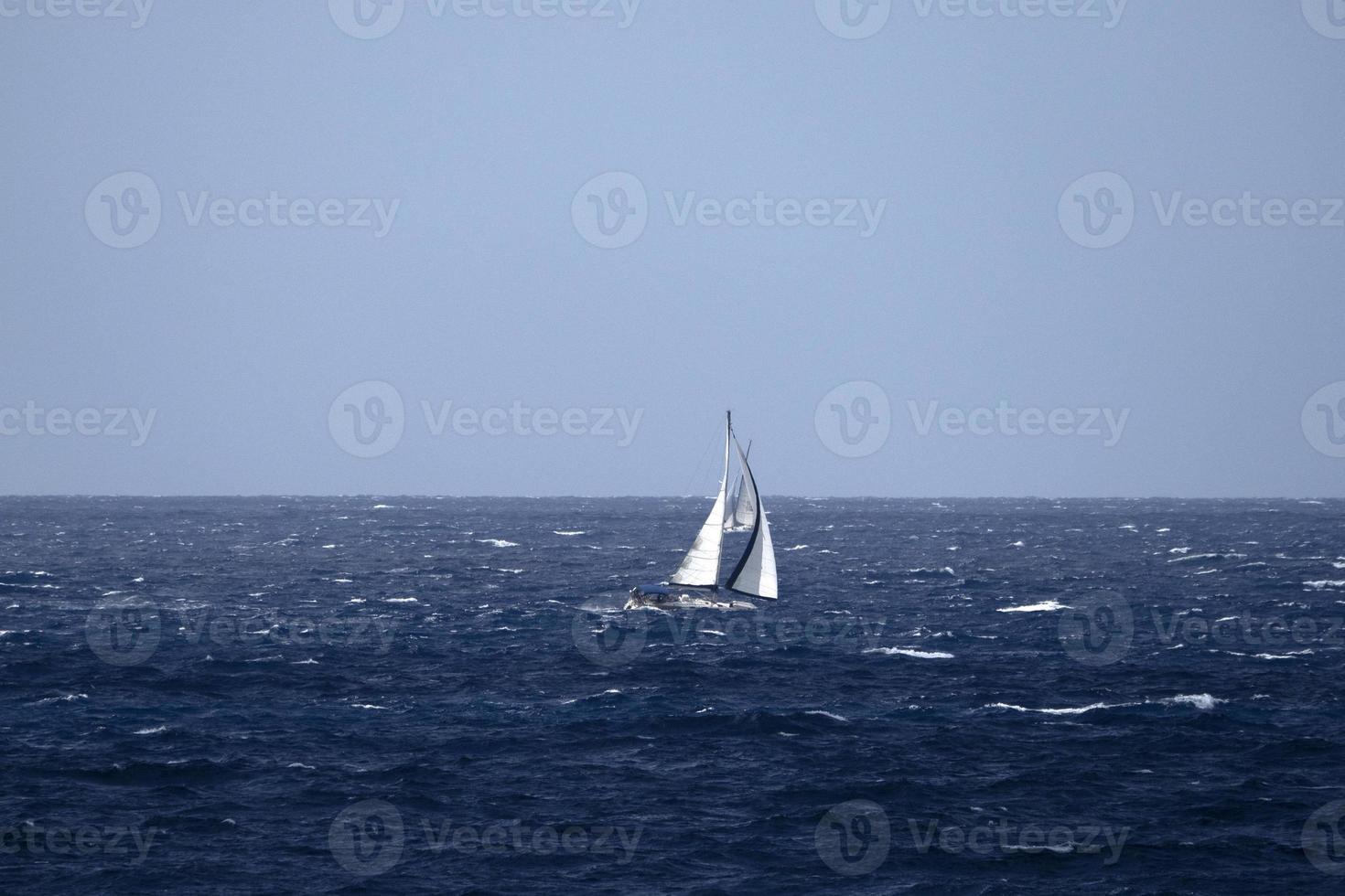 sail boat in high waves sea 20338330 Stock Photo at Vecteezy