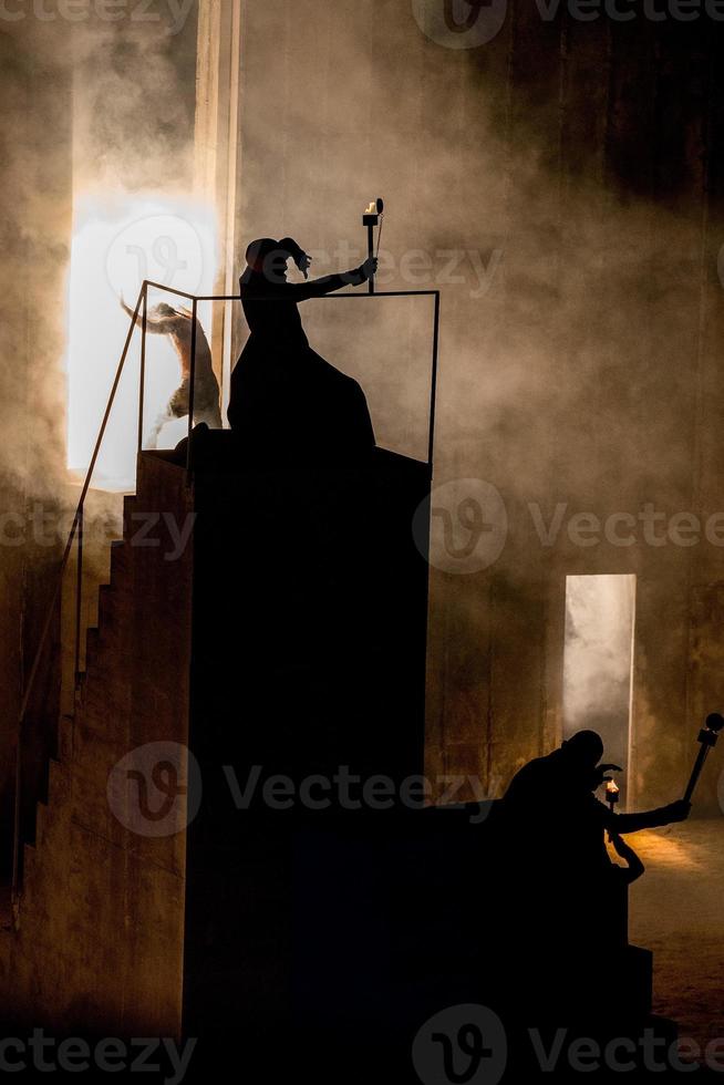 wizard magician silhouette holding a torch photo