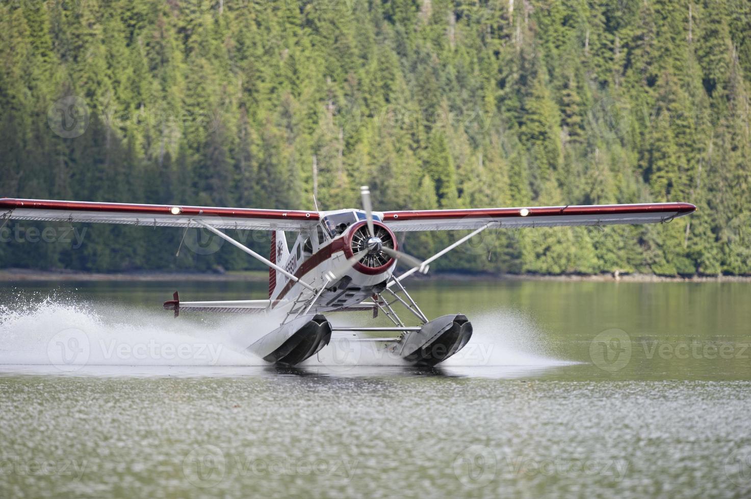 A Floatplane while landing on Alaskan lake photo