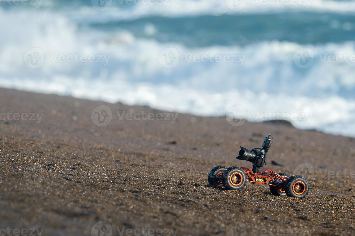 Terrestrial ground drone with camera while driving on the beach photo