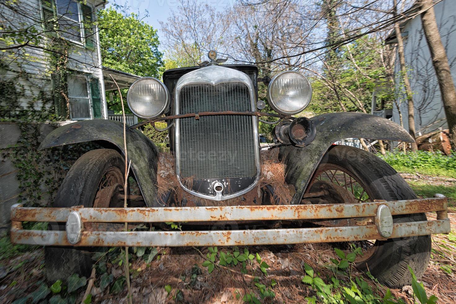 Old abandoned Rusted Car in a field photo
