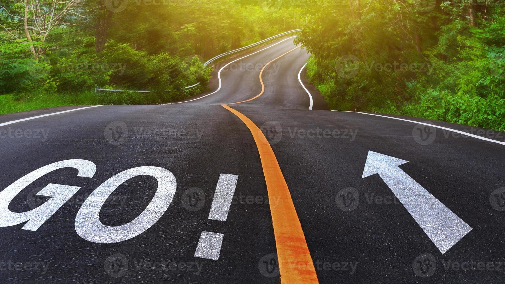 Word Go written on road in the middle of an empty asphalt road for business planning strategies and challenges or career path opportunities and change, road to success concept photo