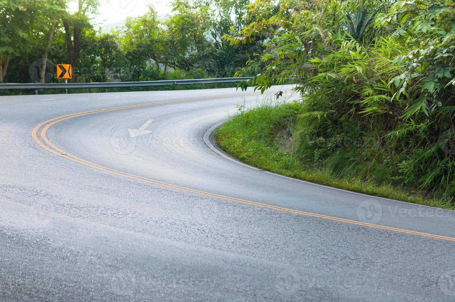 Countryside road with trees on both sides,Curve of the road to mountain photo