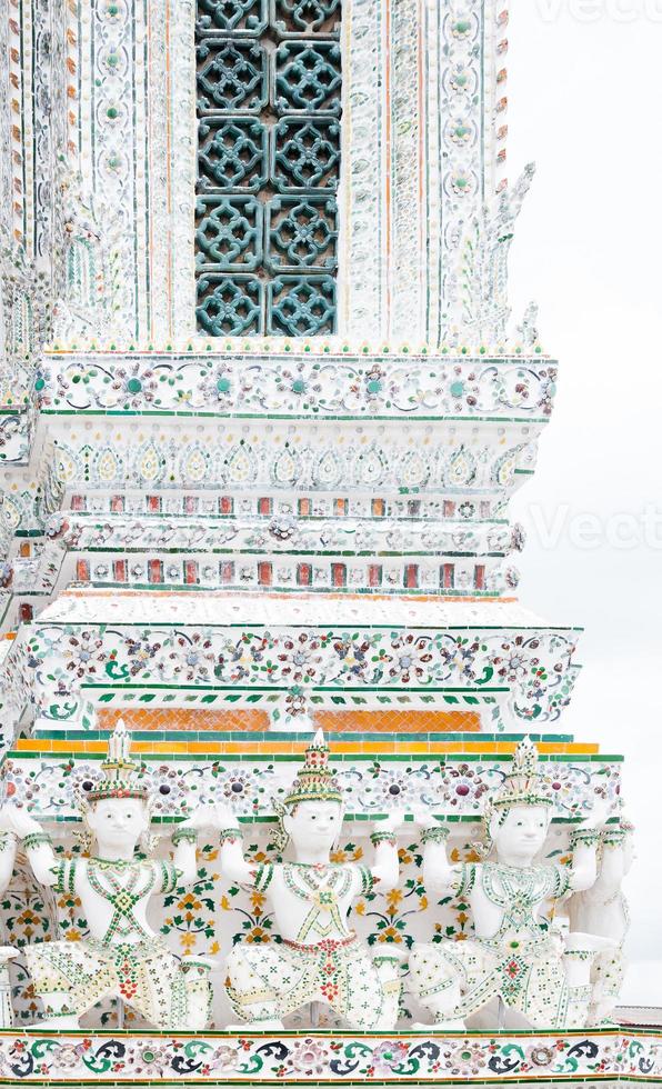 Detail of the temple of Wat Arun with statues of demon guardians,Thailand iconic decorated by ceramics ,Amazing Thailand. Bangkok, Thailand photo