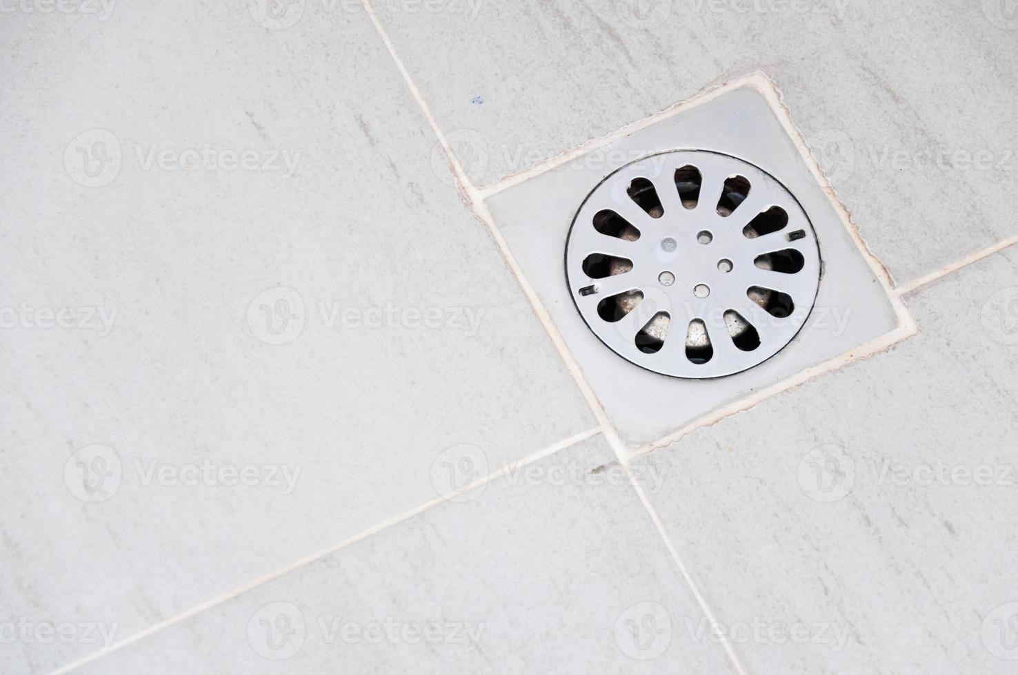 old chrome shower drain set in on a shower photo