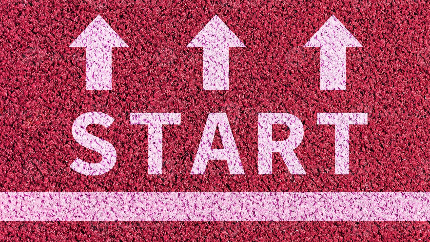 Start line on an athletics track concept and arrow for business planning strategies and challenges or career path opportunities and change, road to success concept photo