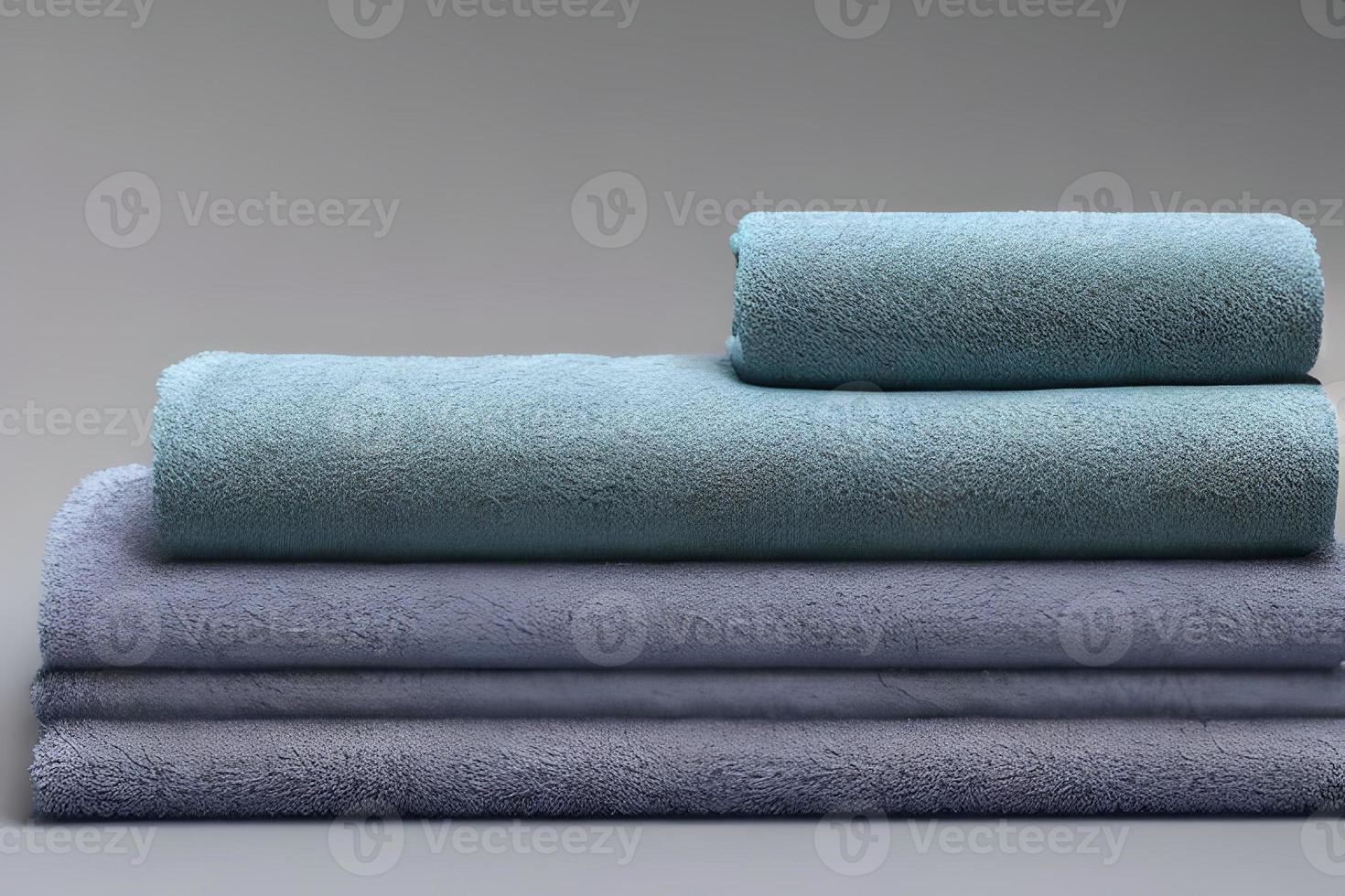 Clean soft blue and green color folded towel nice and tidy stack each other for fitness, bath, swimming, massage and spa marketing background and design material isolated on grey background. photo