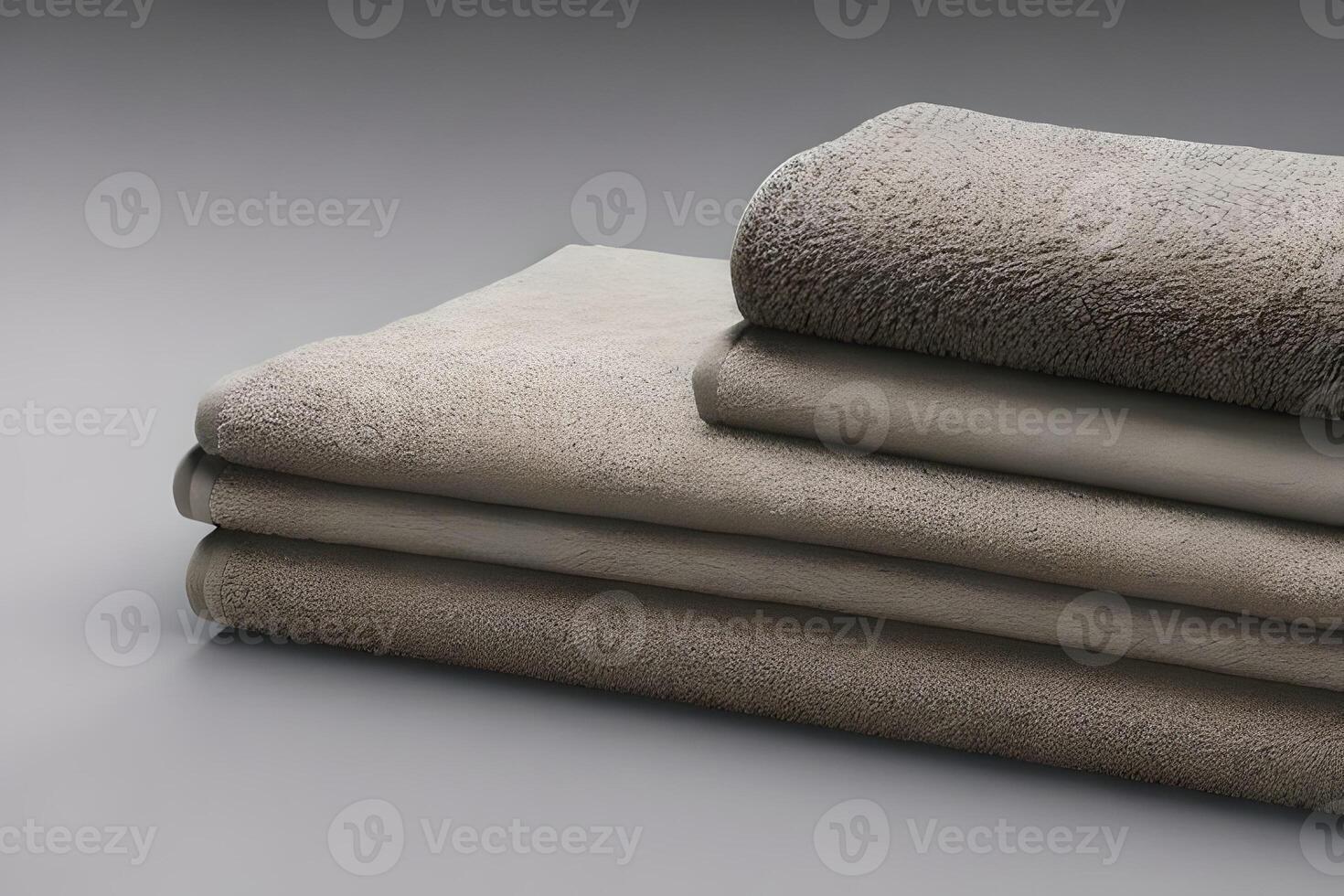 Clean various size soft gray color folded towel nice and tidy stack each other for fitness, bath, swimming, massage and spa marketing background and design material isolated on grey background. photo