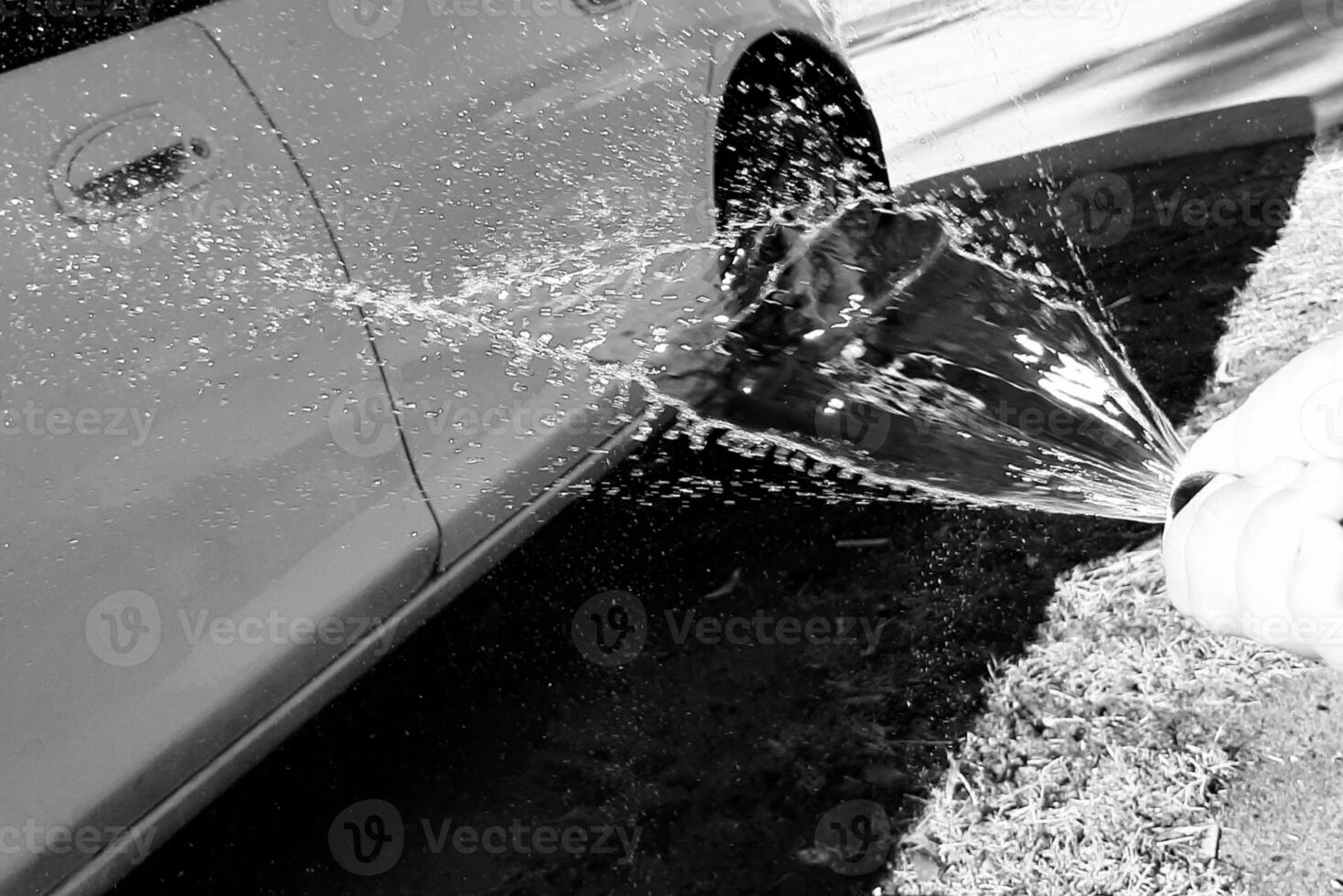 Worker washing car with sponge on a car wash, Manual car wash with