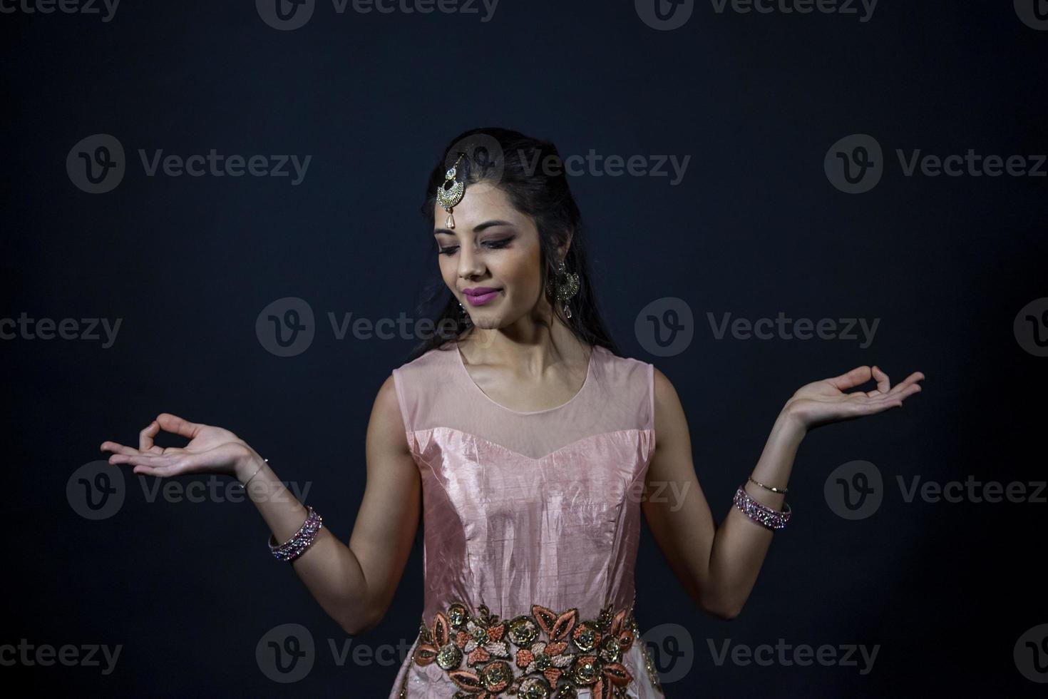 Portrait of smiling beautiful indian girl wearing traditional purple clothes photo