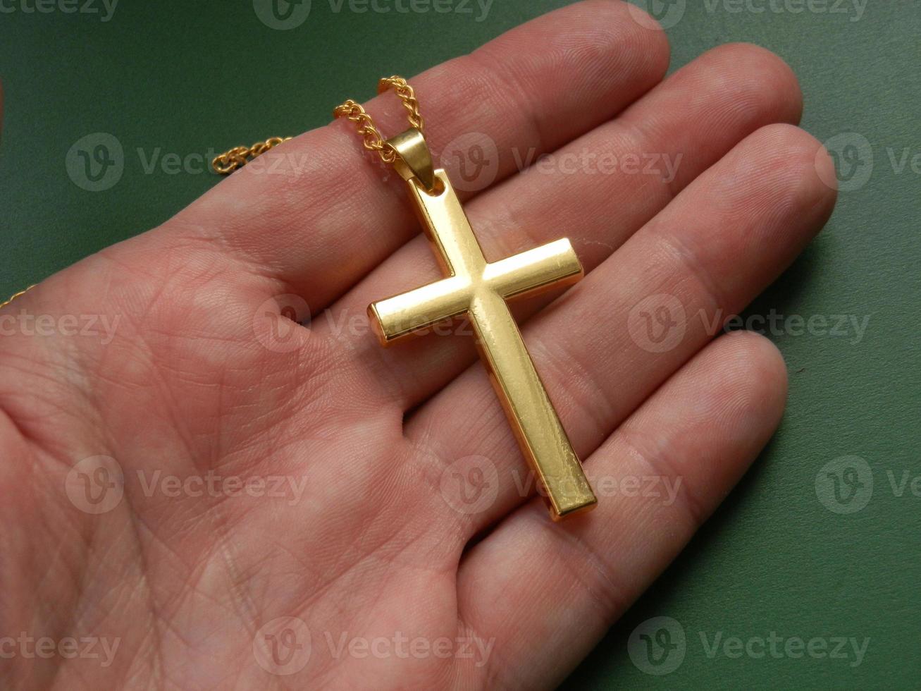 Religious metal symbol medallion in hand photo