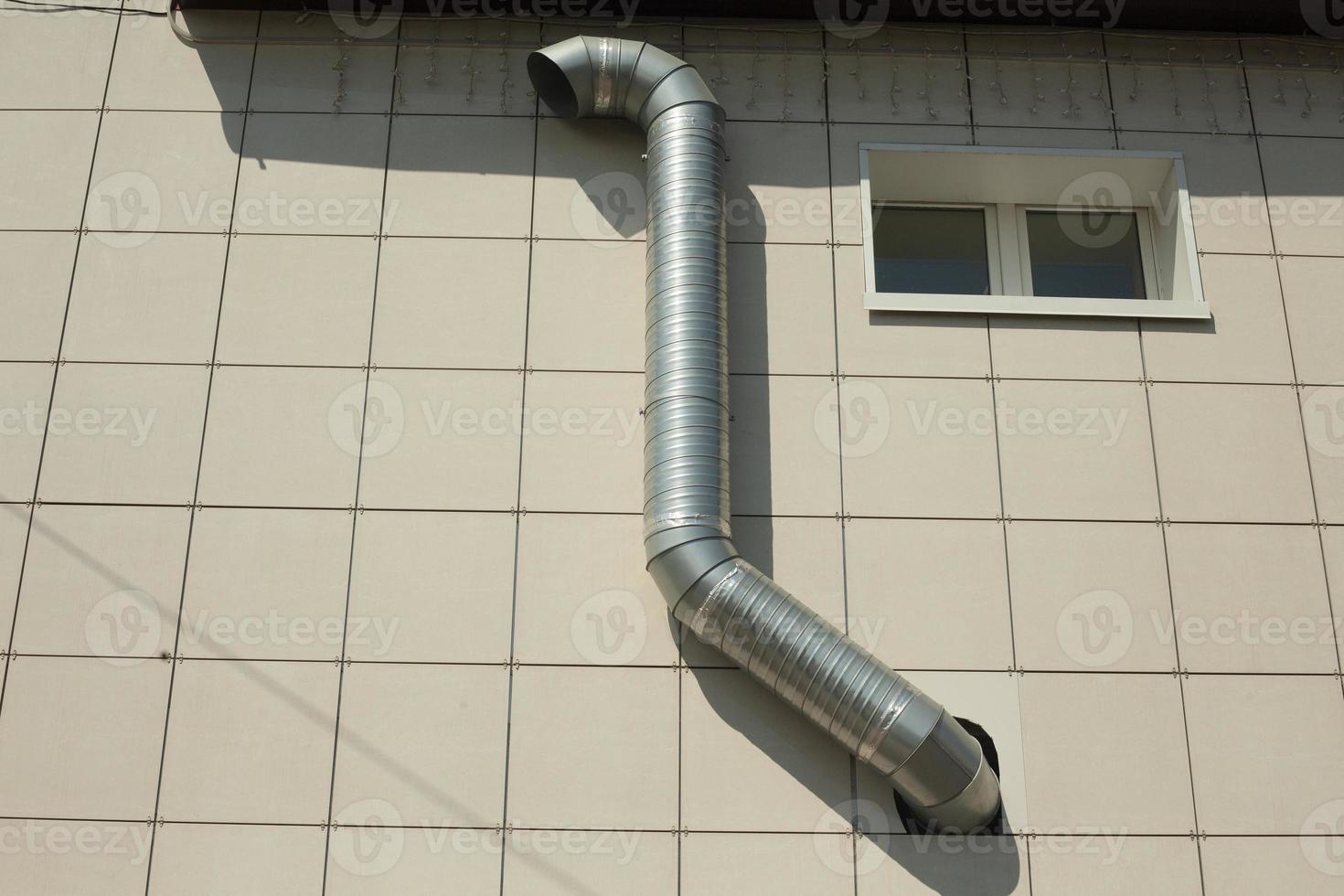 Pipe on building. Ventilation of equipment. Ventilation pipe on wall. photo