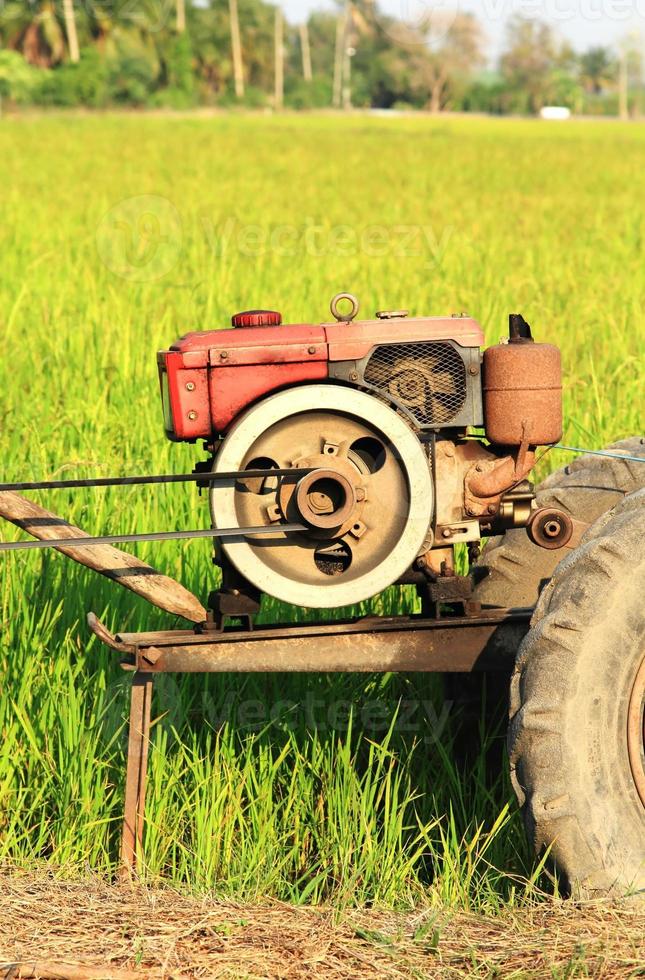 The old red water pump that is spinning at full power to pump water into the rice fields of farmers during the rice growing season in rural Thailand. photo