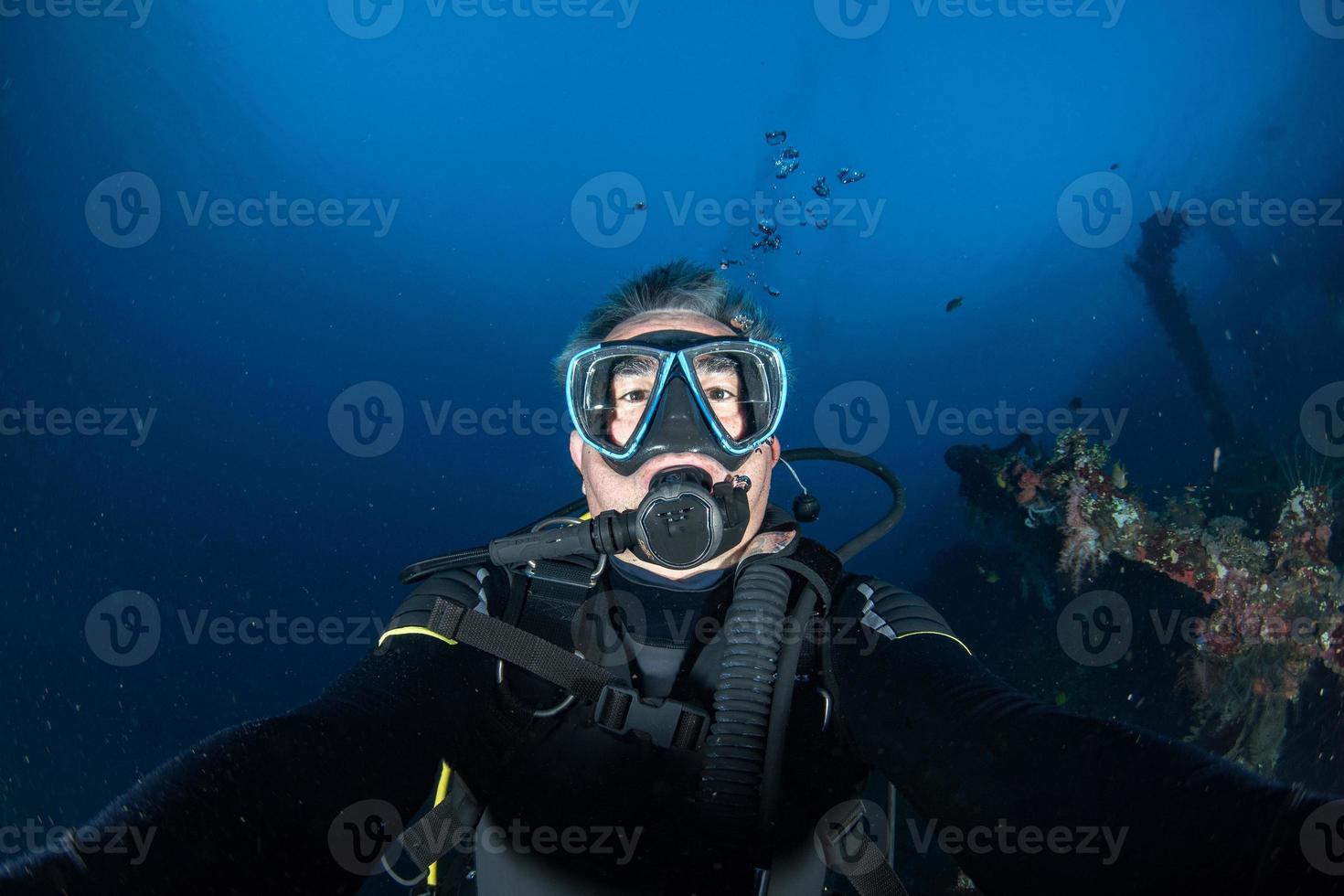 Scuba diver smiling underwater selfie portrait in the ocean photo