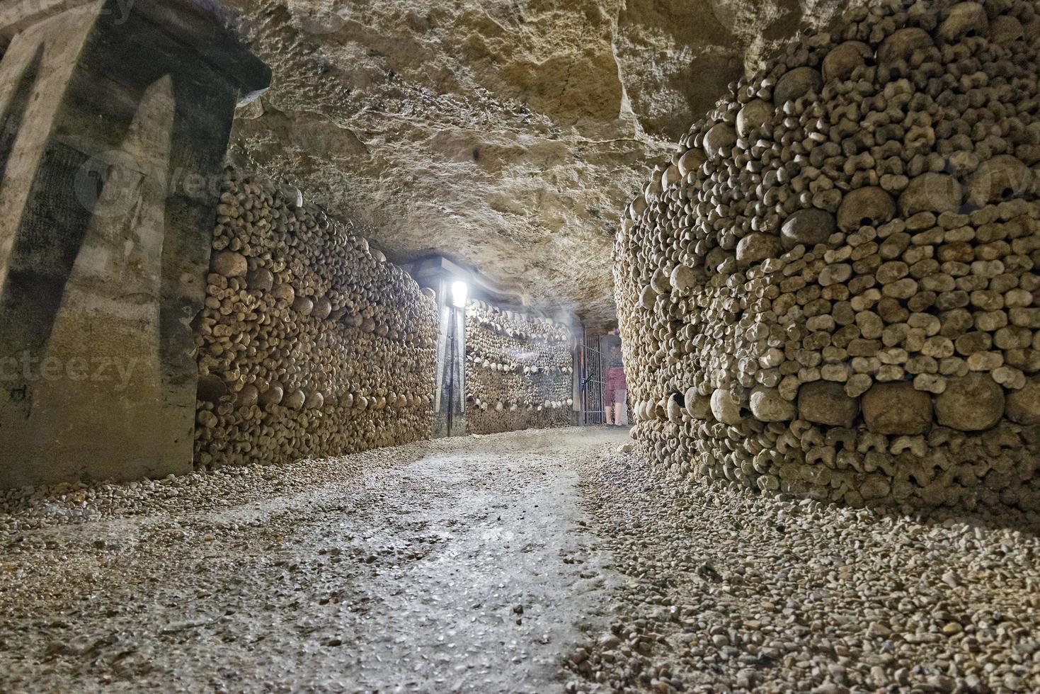a ghost shape inside Paris Catacombs Skulls and bones photo