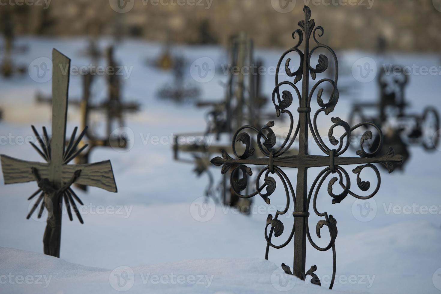 cemetery cross covered by snow photo