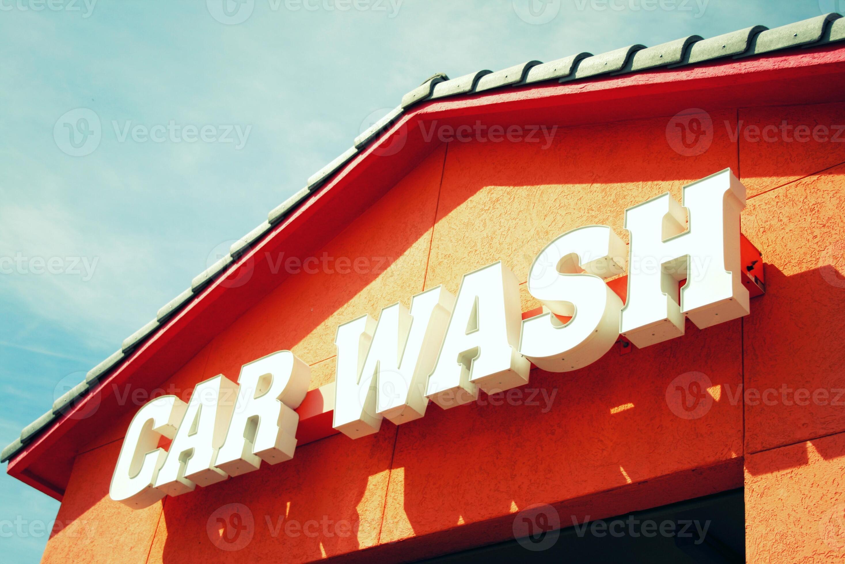Worker washing car with sponge on a car wash, Manual car wash with