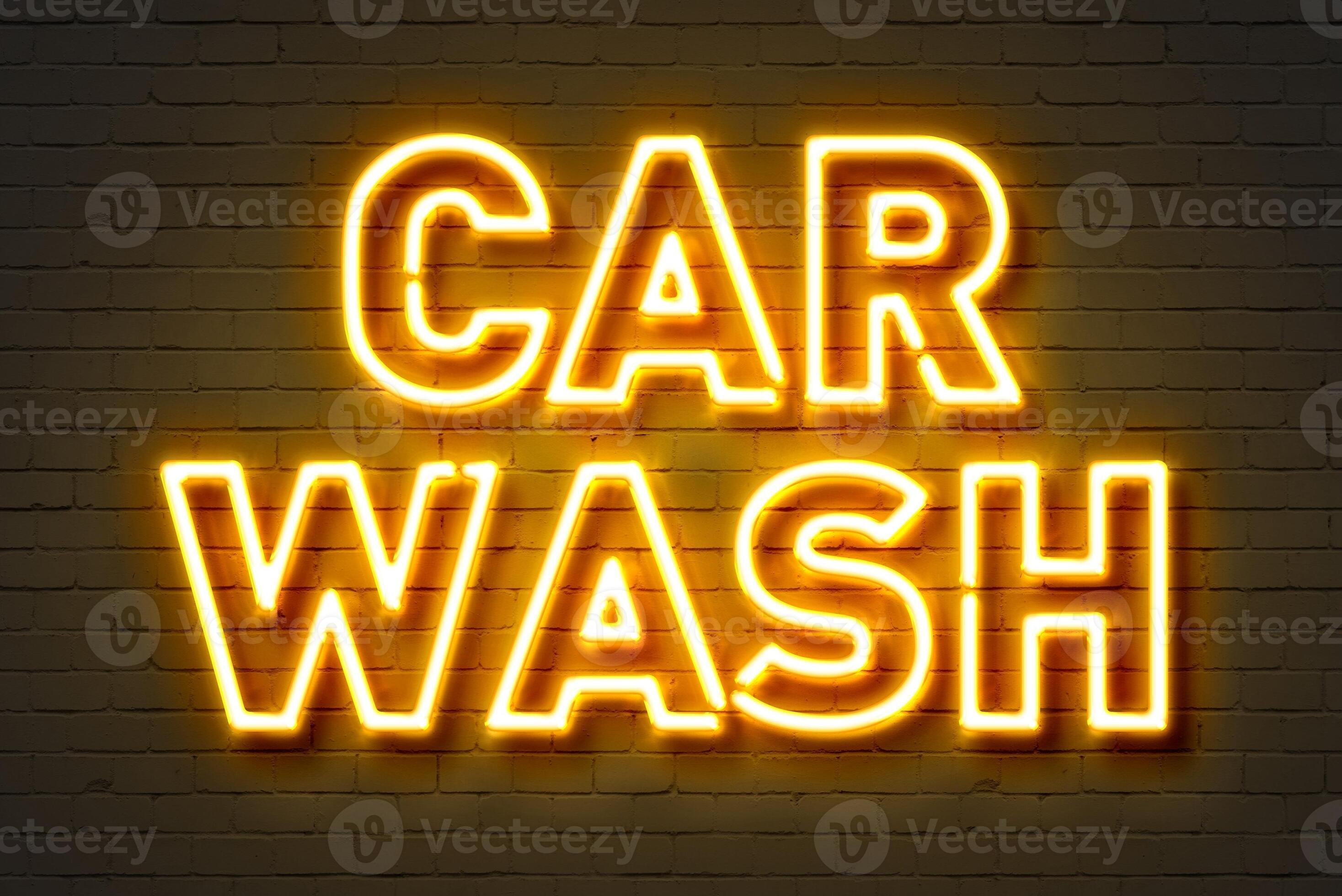 Worker washing car with sponge on a car wash, Manual car wash with