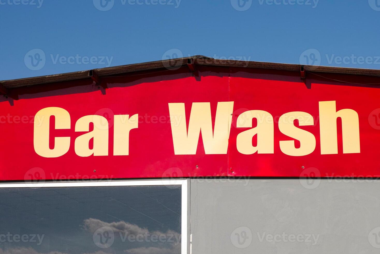 Worker washing car with sponge on a car wash, Manual car wash with