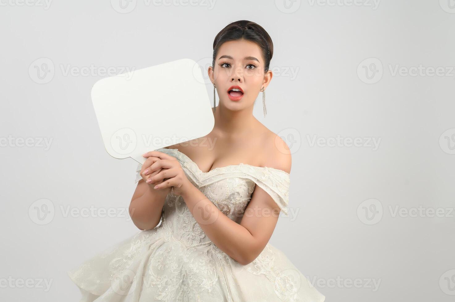 Young asian beautiful bride pose with mockup banner in hand photo