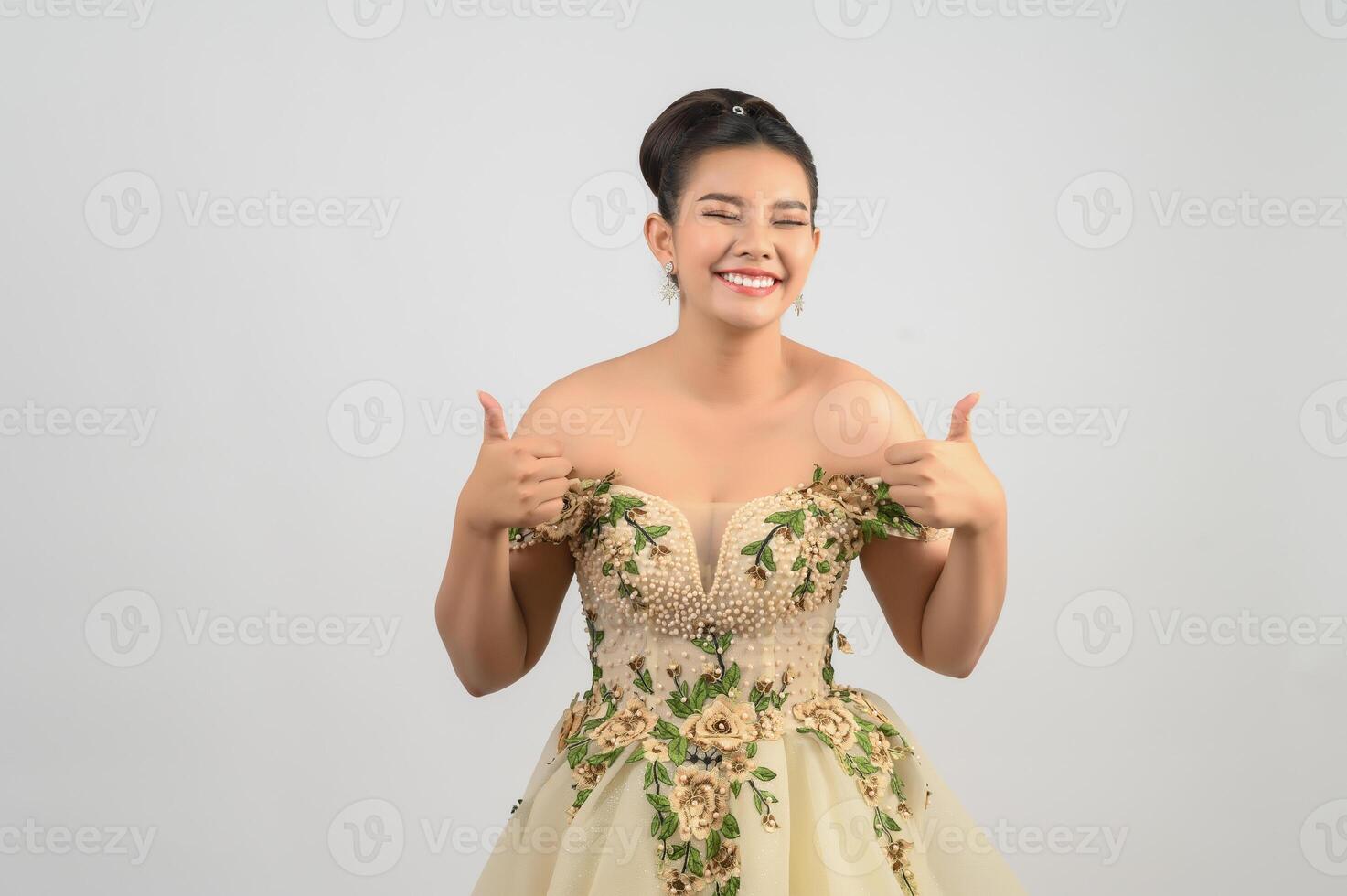 Young asian beautiful bride pose thumb up  on white background photo